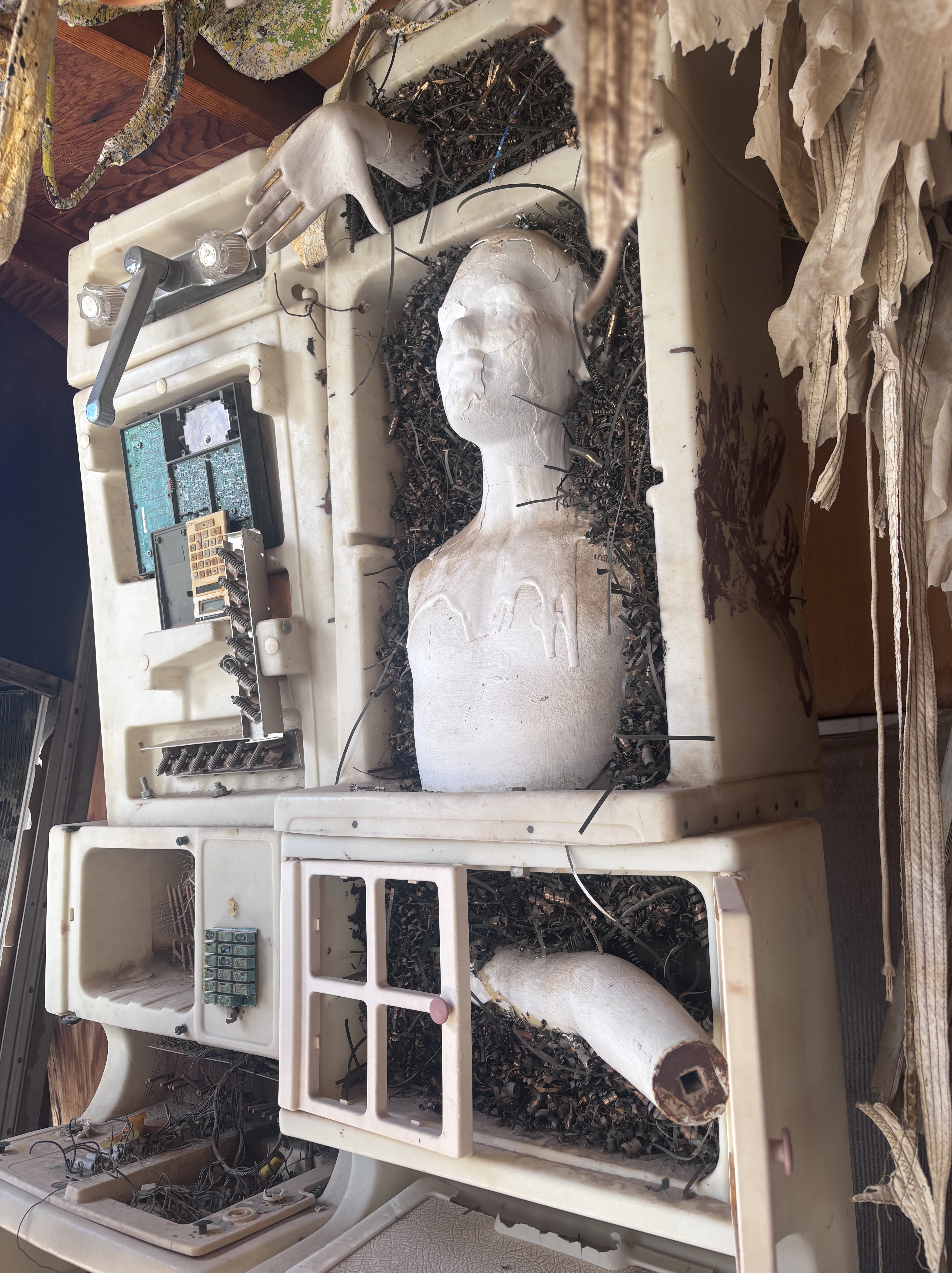 Found object art featuring a play sink and mannequin pieces.