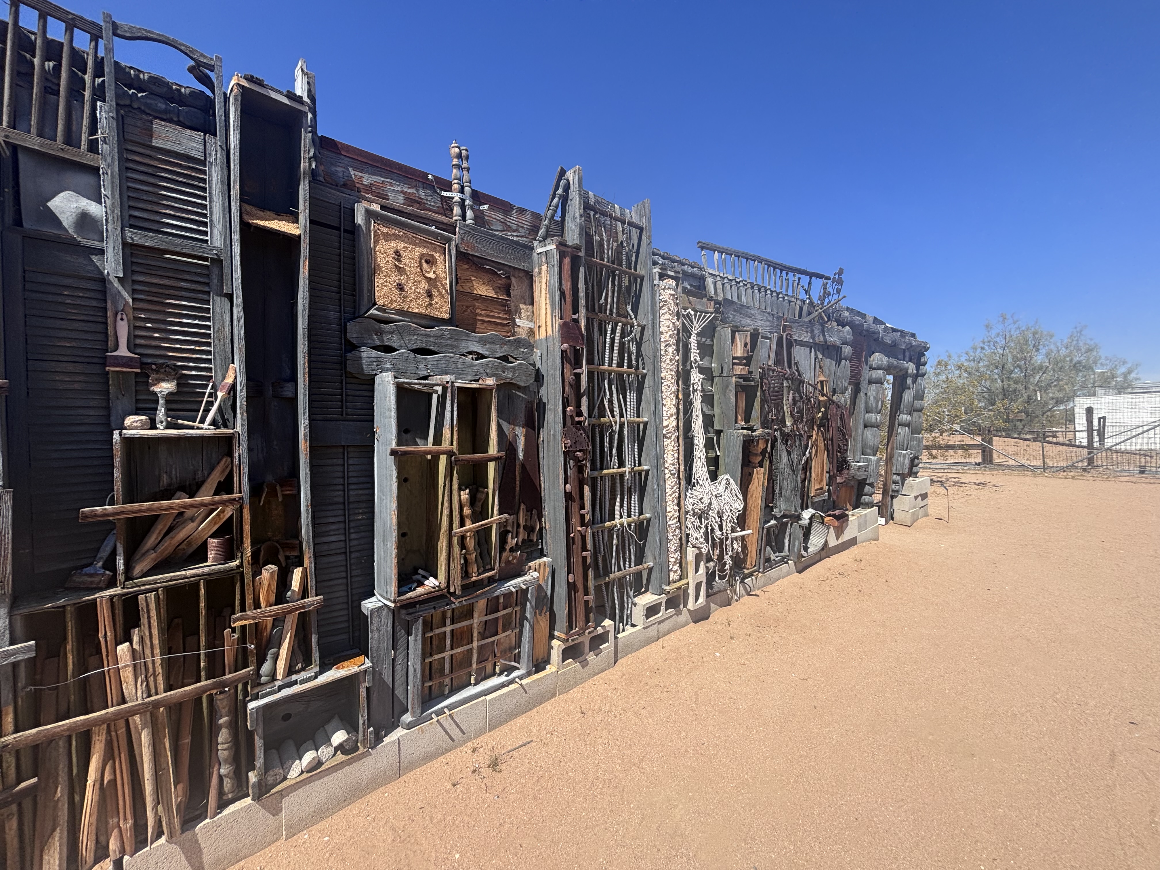 A building frontage with lots of scrap and recycled materials